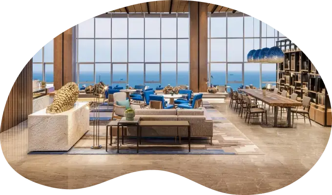 Luxury hotel interior with ocean views, contemporary furniture, and elegant dining area